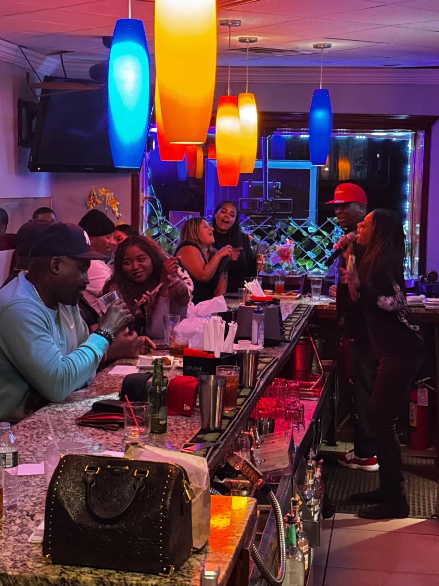 Guests singing with microphones during a Spices Negril lounge evening